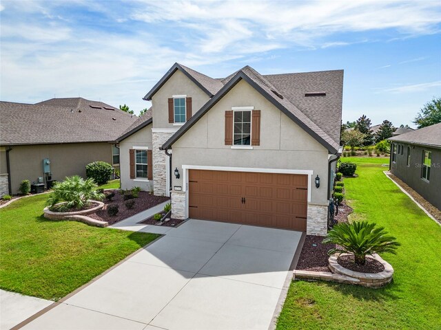 view of front of property with a front yard and a garage