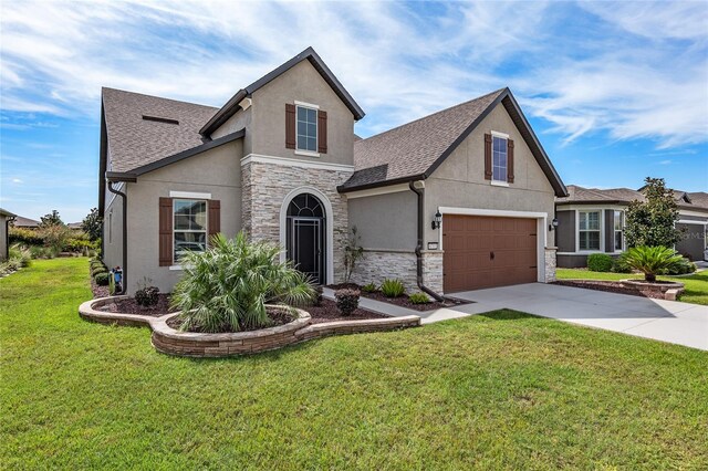 view of front of property featuring a front yard and a garage