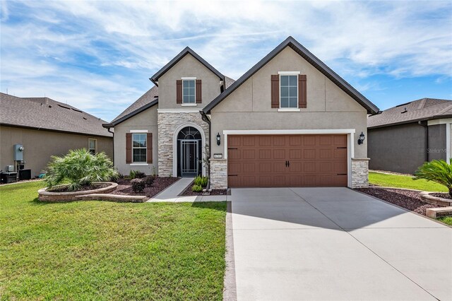 view of front of home featuring a front yard and a garage