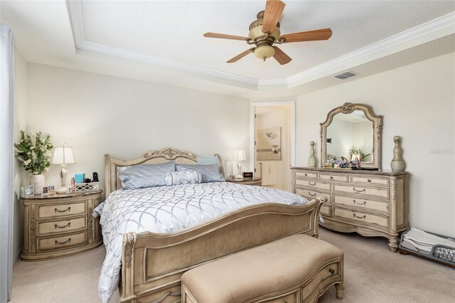 carpeted bedroom featuring ceiling fan, a raised ceiling, and ornamental molding