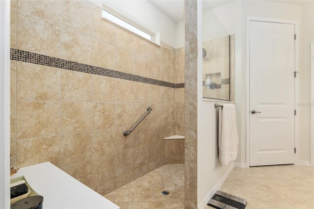 bathroom featuring tile floors and tiled shower