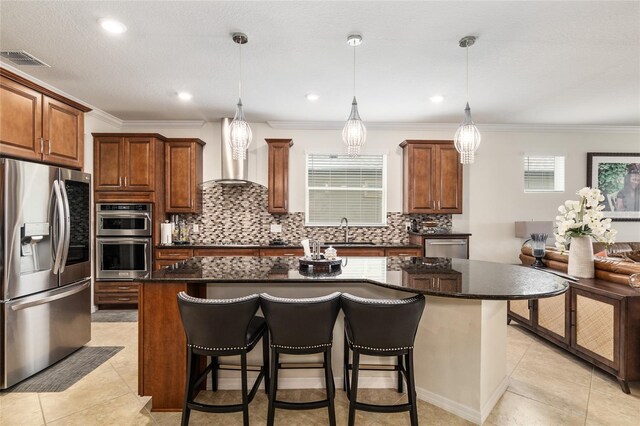 kitchen featuring a breakfast bar, a kitchen island, and appliances with stainless steel finishes