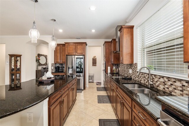 kitchen with sink, light tile floors, dark stone counters, tasteful backsplash, and decorative light fixtures