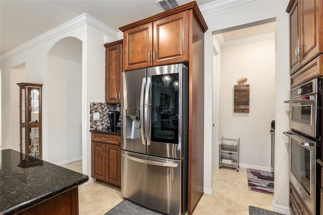 kitchen with tasteful backsplash, stainless steel appliances, light tile floors, and crown molding