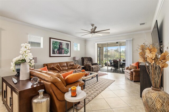 living room with crown molding, ceiling fan, and light tile floors