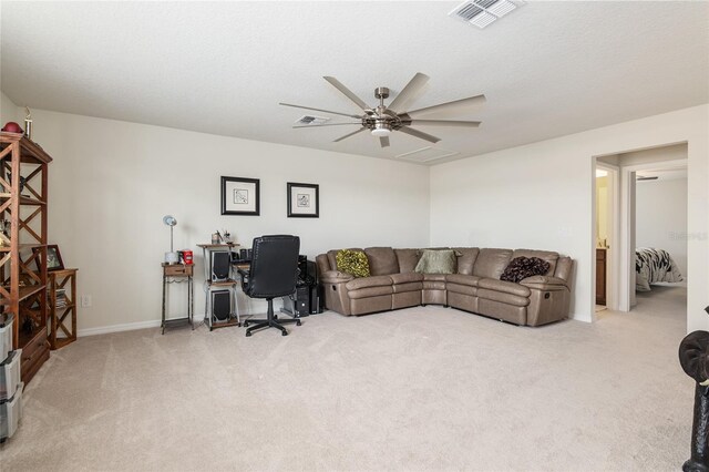 carpeted home office with ceiling fan