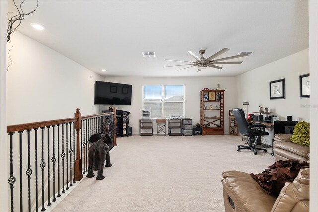 carpeted home office with ceiling fan