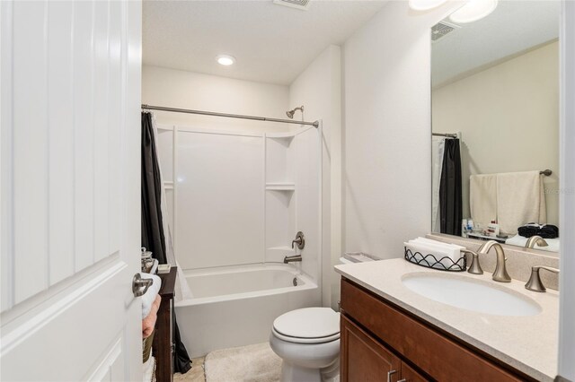 full bathroom featuring shower / tub combo, oversized vanity, and toilet