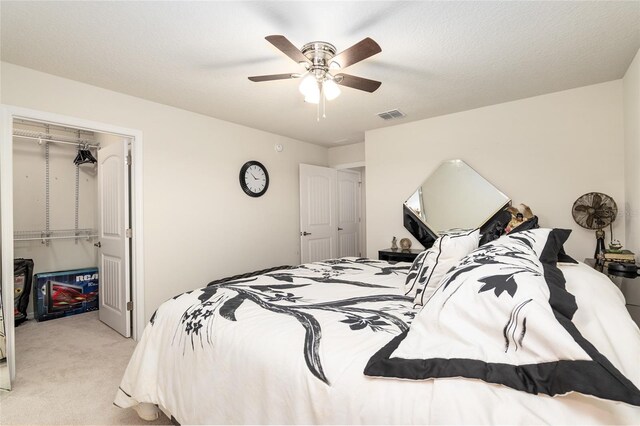 bedroom with light carpet, a closet, and ceiling fan