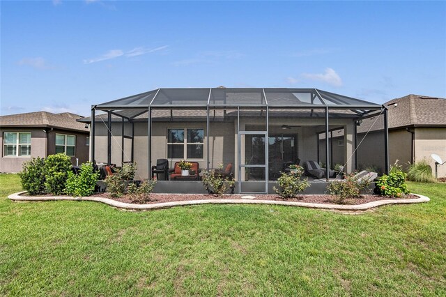 back of property with a yard and glass enclosure