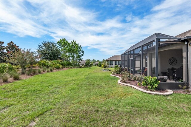 view of yard with glass enclosure