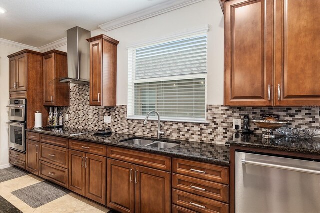 kitchen with light tile flooring, sink, stainless steel appliances, dark stone countertops, and wall chimney range hood