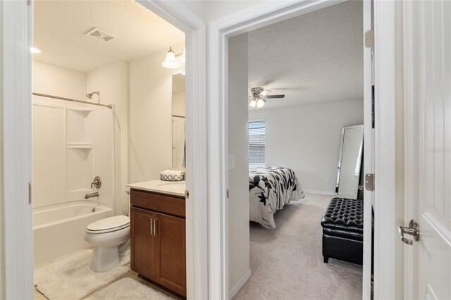 full bathroom with vanity, ceiling fan, a textured ceiling, shower / bathtub combination, and toilet