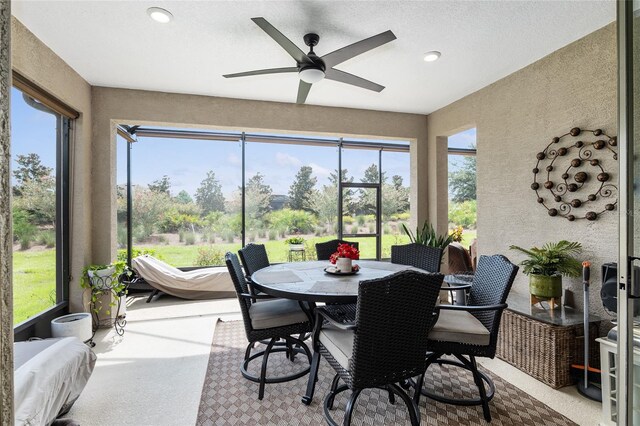 sunroom featuring ceiling fan