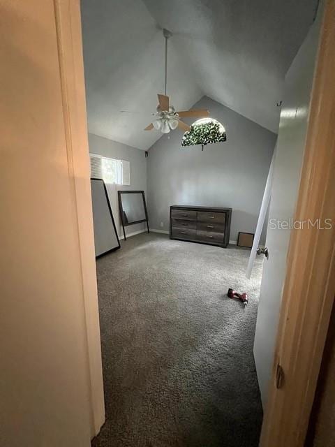 interior space with carpet floors, ceiling fan, and lofted ceiling