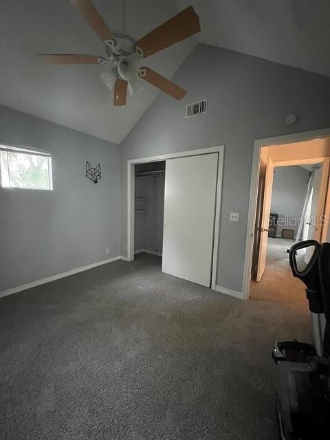 unfurnished bedroom with ceiling fan, a closet, dark colored carpet, and high vaulted ceiling