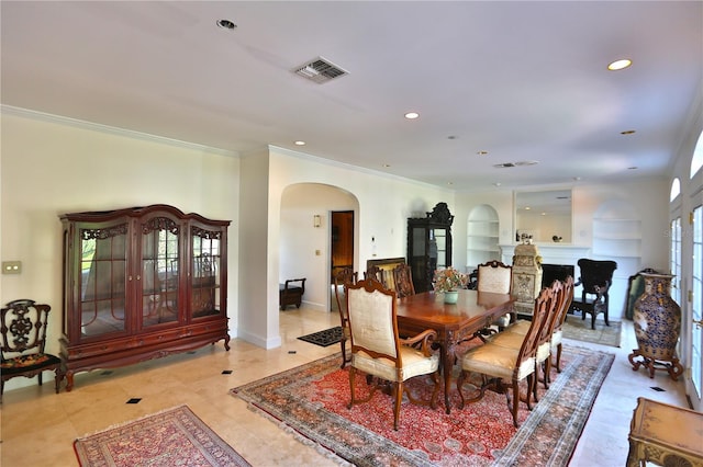 dining area with light tile flooring, ornamental molding, and built in features