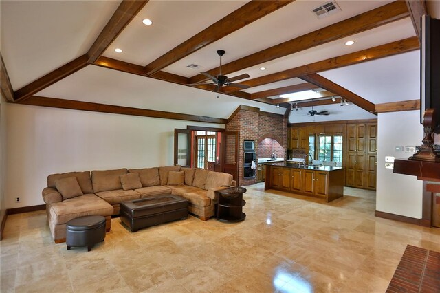 tiled living room featuring ceiling fan, a wealth of natural light, and beamed ceiling