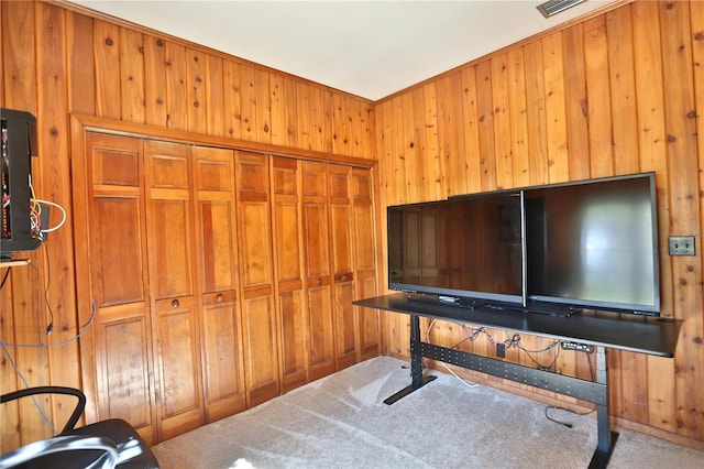 miscellaneous room with carpet floors and wood walls