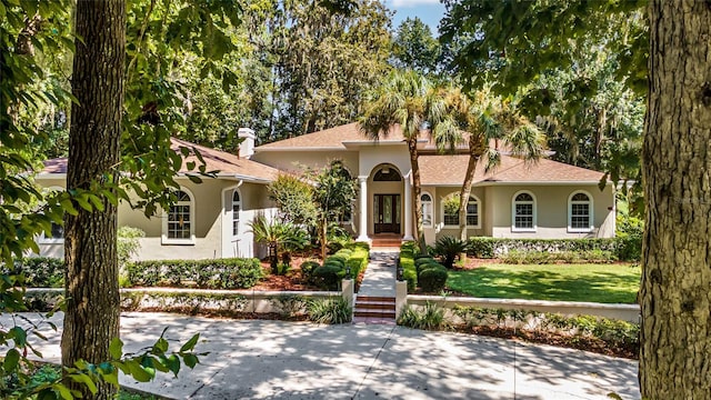 mediterranean / spanish house with a front lawn