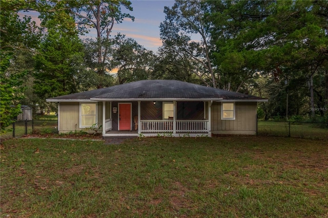 ranch-style house featuring a yard and a porch