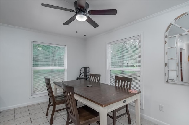 dining space featuring light tile flooring, ceiling fan, and crown molding