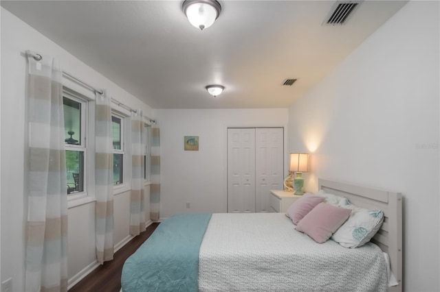 bedroom featuring dark hardwood / wood-style flooring and a closet