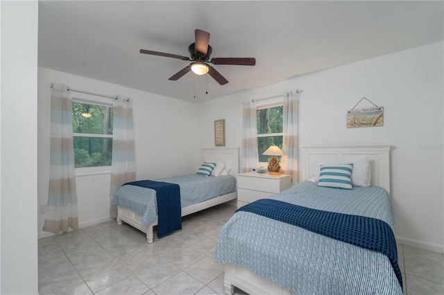 tiled bedroom with ceiling fan