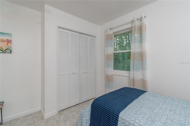 bedroom featuring a closet and light tile flooring