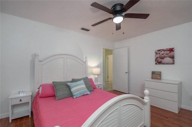 bedroom with ceiling fan and dark hardwood / wood-style floors