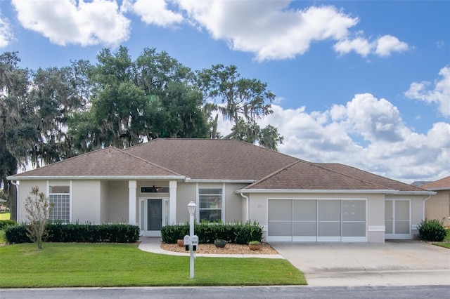 ranch-style house featuring a front yard and a garage