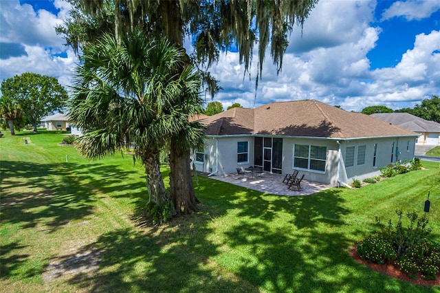 back of house featuring a patio area and a yard