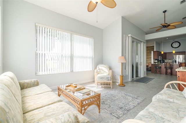 living room with light tile floors and ceiling fan