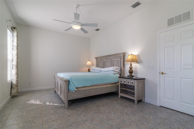 tiled bedroom with multiple windows and ceiling fan