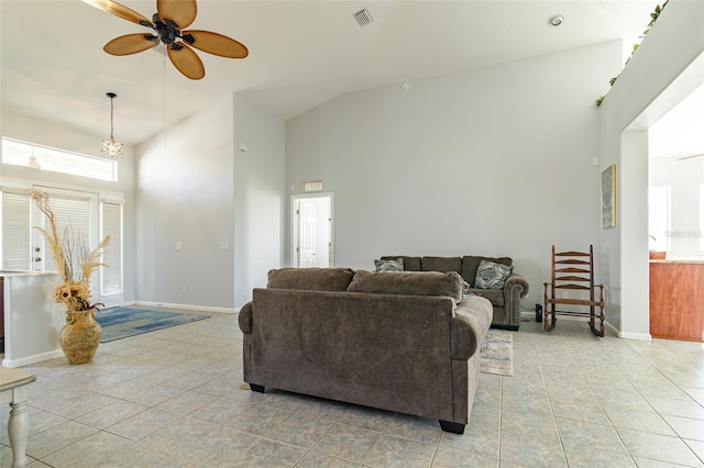 living room featuring light tile flooring, a healthy amount of sunlight, ceiling fan, and high vaulted ceiling