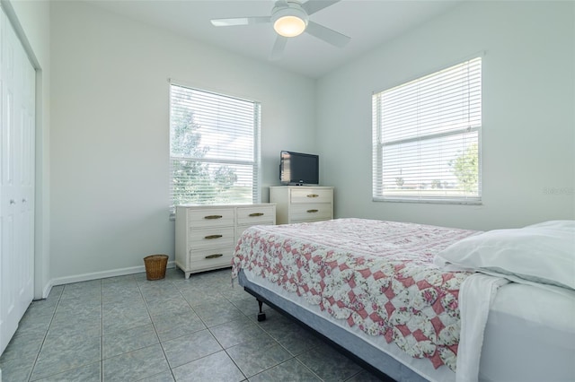 bedroom featuring tile floors, a closet, and ceiling fan