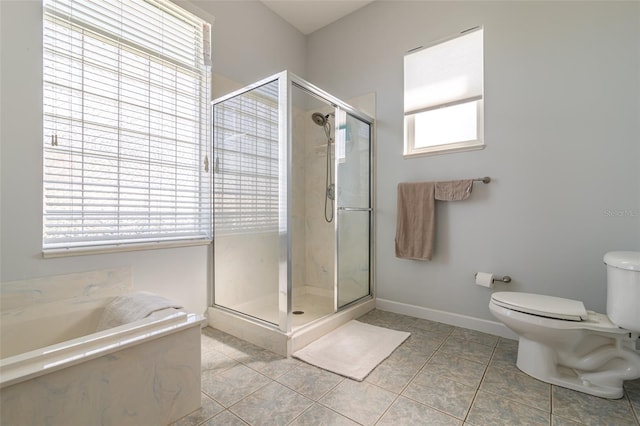 bathroom featuring tile floors, toilet, and separate shower and tub