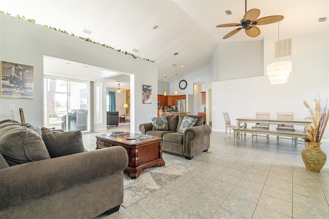 living room featuring light tile floors, ceiling fan, and high vaulted ceiling