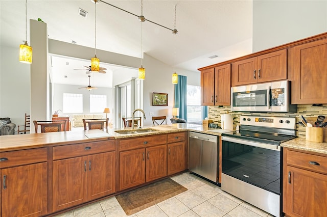 kitchen featuring backsplash, a healthy amount of sunlight, and appliances with stainless steel finishes