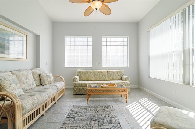 tiled living room featuring ceiling fan and a healthy amount of sunlight