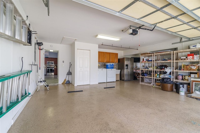 garage with washer and clothes dryer, a garage door opener, and stainless steel fridge with ice dispenser