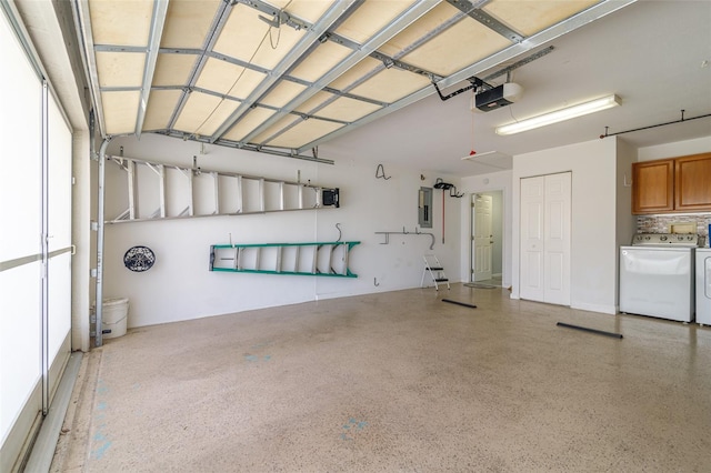 garage with separate washer and dryer and a garage door opener