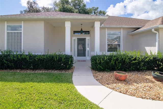 entrance to property featuring a yard