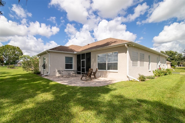 rear view of property featuring a patio area and a yard