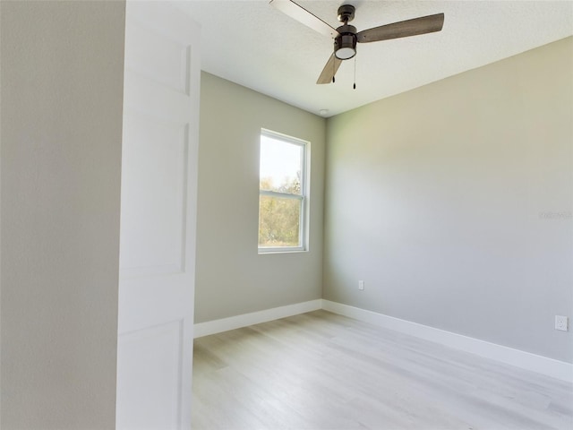 spare room featuring ceiling fan and light wood-type flooring