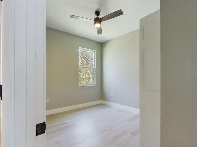 unfurnished room featuring ceiling fan and light wood-type flooring