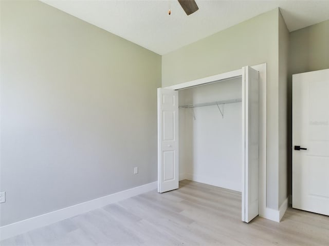 unfurnished bedroom featuring a closet, ceiling fan, and light hardwood / wood-style flooring