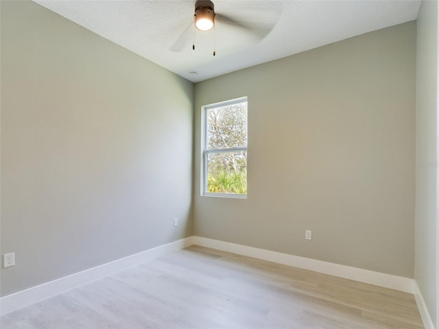 spare room with light hardwood / wood-style flooring and ceiling fan