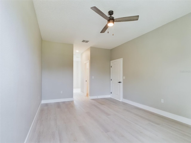 spare room with ceiling fan and light hardwood / wood-style flooring