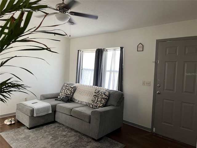 living room with dark hardwood / wood-style floors and ceiling fan